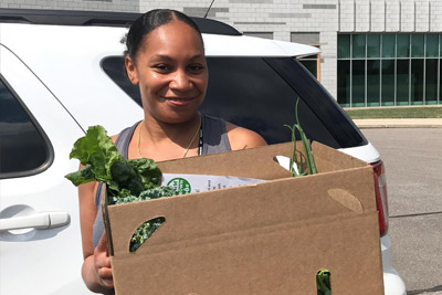 Volunteer registering cars at a mobile food pantry